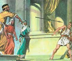 Saul throws spear at David